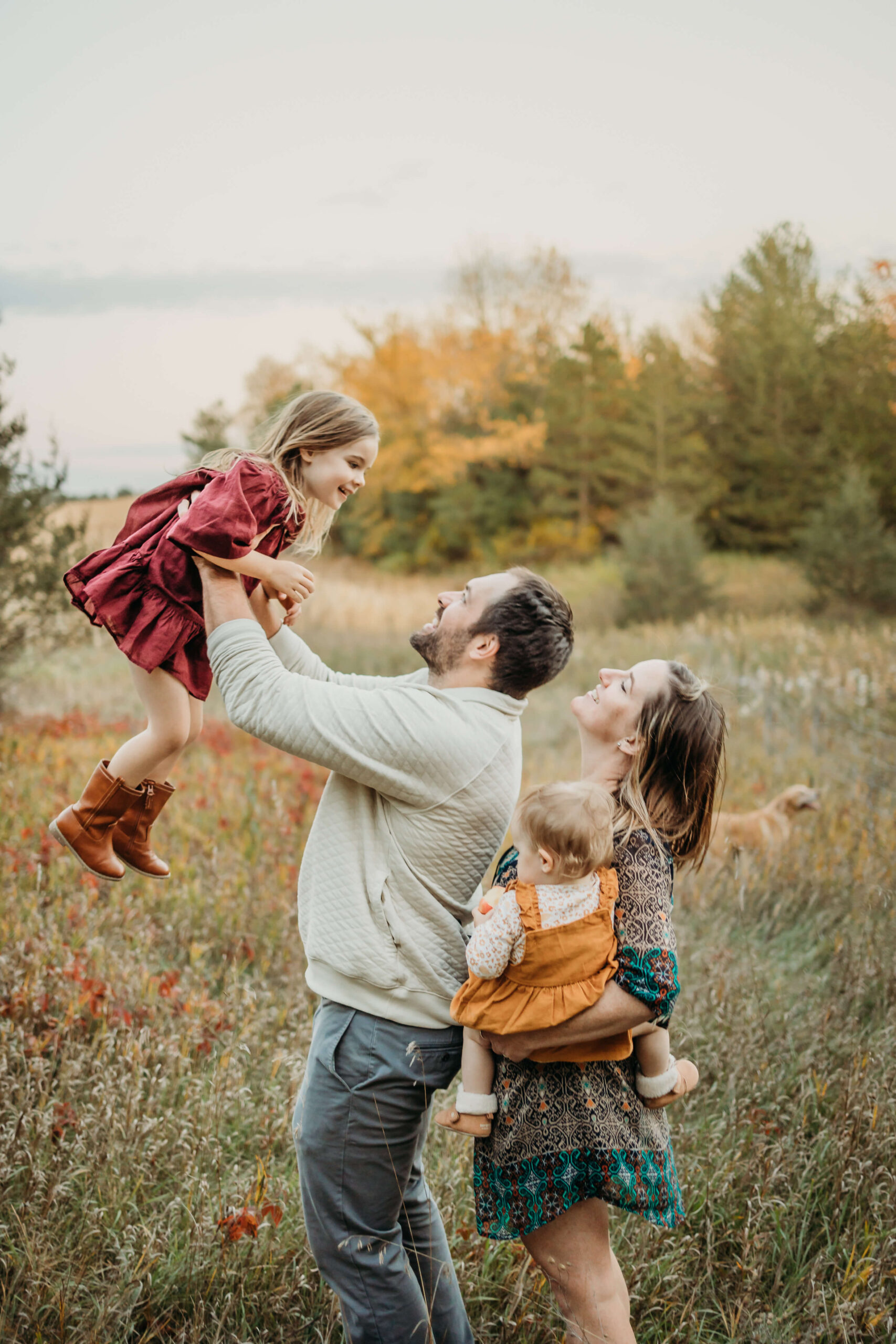 dad lifting young daughter in the air while the family laughs behind them in a field Parenthood is so precious, but it can be challenging to remember to enjoy it. By scheduling some new things to do in Eau Claire, WI, you’ll create wonderful memories your entire family will cherish. 