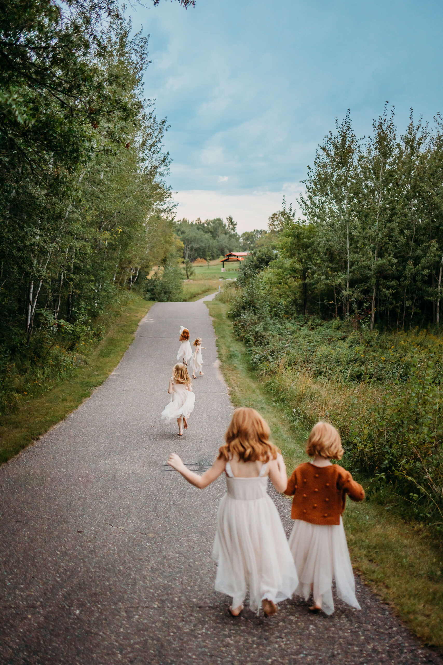 little girls running down an empty road